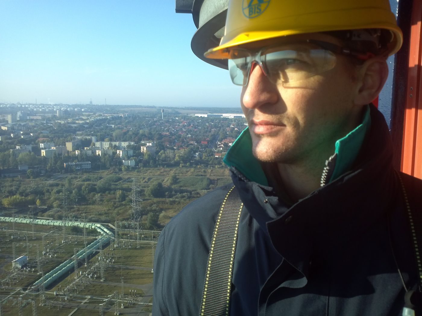 Mihály Madár in a safety helmet on top of an industrial chimney